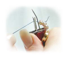 Beads and thread in knotting tool